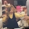 A young child laughing while playing indoors